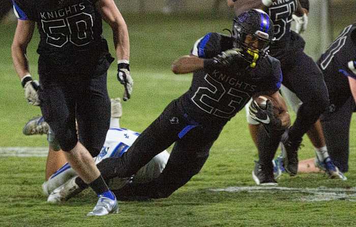 Catholic's Jeremiah Cobb (23) is brought down by his feet in a tackle during the second half on November 5, 2021. 1105 Catholic Vs Houston Academy